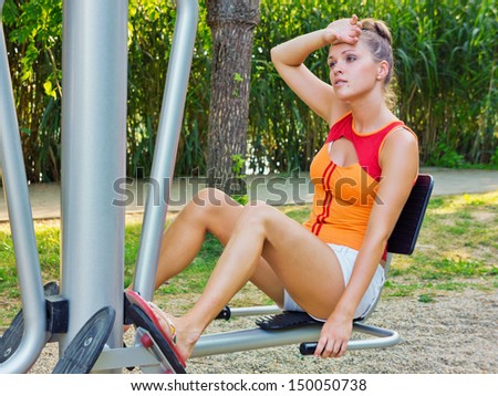 Training in the park / Beautiful young woman training in the park on a gym bench