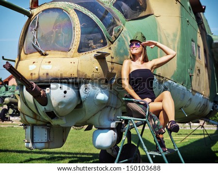 Salute to the veteran gunship / Beautiful young woman salute to the veteran attack helicopter