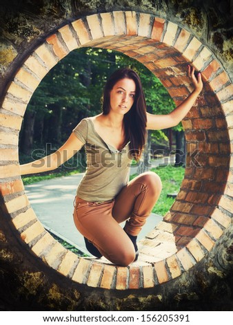 Beauty in the circle / Beautiful young woman in a brick circle