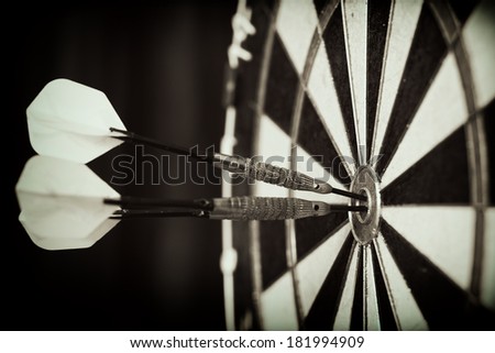 Bull\'s-Eye ! / Vintage style photo from three darts hit the double Bull\'s-Eye