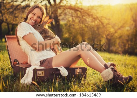 Friendship with an Easter Bunny / Vintage style photo from a beautiful young woman with her bunny