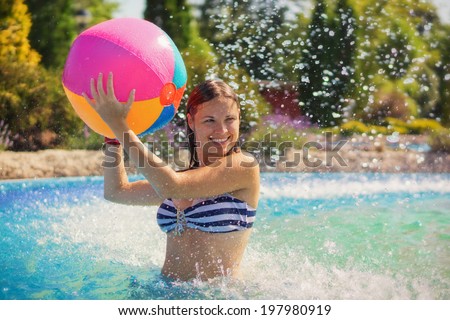 Summer game / Young woman playing with a beachball
