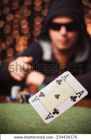 The winner / Poker player throw an Ace in a casino