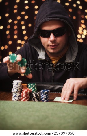 The tricker / Poker player show a trick in a casino