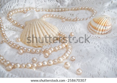 Shells and pearls / Jewels and shells on a lace textile