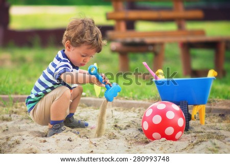 Young boy / Little kid playing around the playground