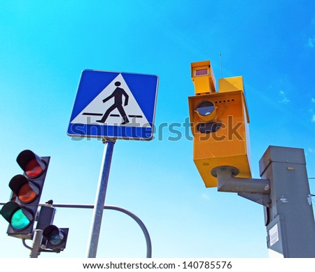 Speed camera and Traffic Light on Green against a Blue Sky