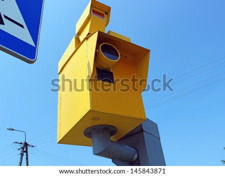 Speed camera and Traffic Light on Green against a Blue Sky