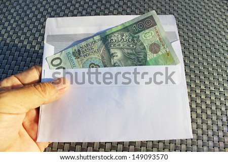 Hand and money in envelope