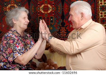 seventy year old couple clap one`s hands