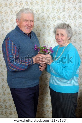 happy old couple with natural flowers