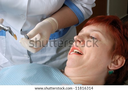 woman with open mouth look on her extract tooth