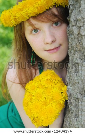 girl with red hair and diadem from yellow dandelions on head