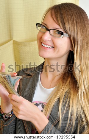 Young pretty successful woman counts money