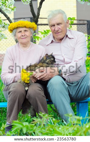 two pretty elderly peoples with cat on the hand