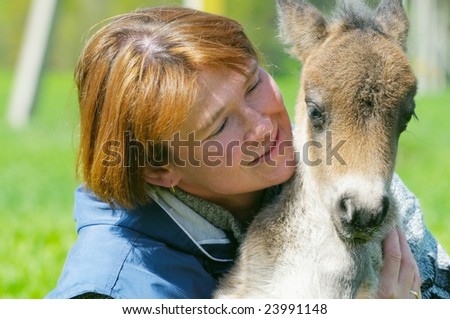 little pony with woman on nature