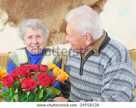 old woman with roses and old man sit near her