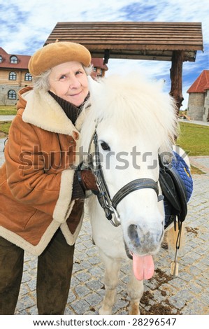 happy granny with pony outdoor