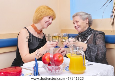 two happy womans drinking wine
