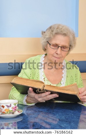 old lady holding a book for reading