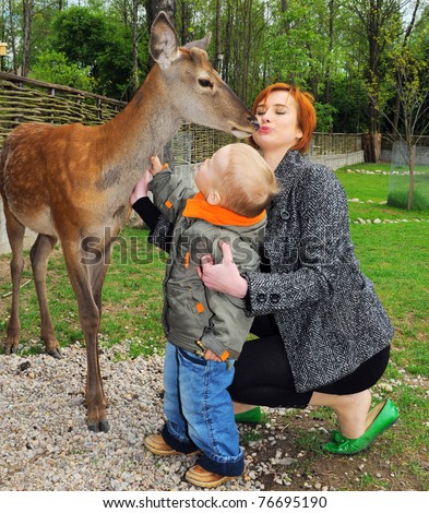 young mother and son pet  deer