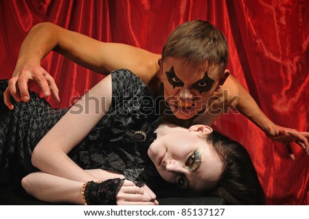 vampire and pale woman on red background