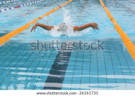 Man swimming laps in a community competition swimming pool