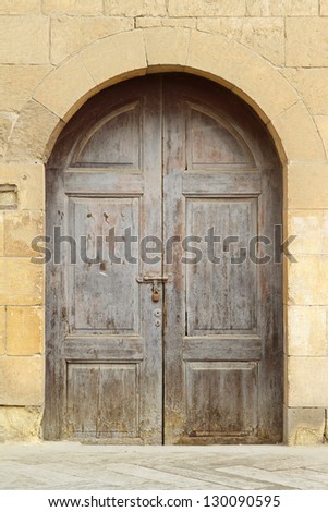 Double wooden door with arch castle entrance