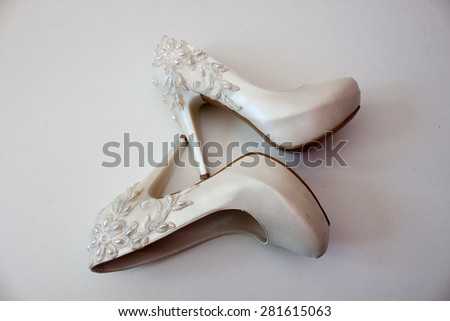 White shoes with pearls and high heels on a white background