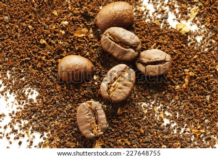 Background of ground coffee beans with coffe beans