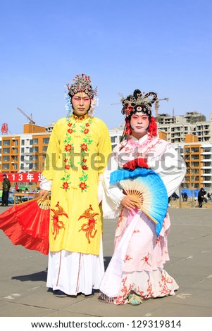 LUANNAN COUNTY - FEBRUARY 18: During the Chinese Lunar New Year, people wear colorful clothes, yangko dance performances in the streets, on February 18, 2013, Luannan County, Hebei Province, China.