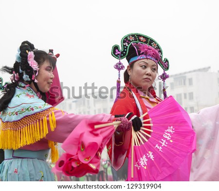 LUANNAN COUNTY - FEBRUARY 17: During the Chinese Lunar New Year, people wear colorful clothes, yangko dance performances in the streets on February 17, 2013, Luannan County, Hebei Province, China.