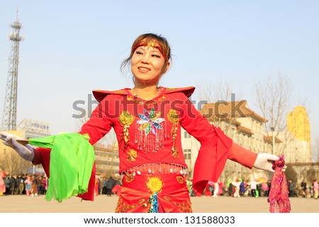LUANNAN COUNTY - FEBRUARY 18: During the Chinese Lunar New Year, people wear colorful clothes, yangko dance performances in the street on February 18, 2013, Luannan County, Hebei Province, China.