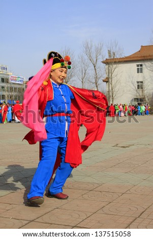 LUANNAN COUNTY - FEBRUARY 18: During the Chinese Lunar New Year, people wear colorful clothes, yangko dance performances in the streets, on February 18, 2013, Luannan County, Hebei Province, China.