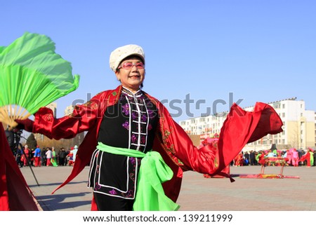 LUANNAN COUNTY - FEBRUARY 19: During the Chinese Lunar New Year, people wear colorful clothes, yangko dance performances in the streets, on February 19, 2013, Luannan County, Hebei Province, China.