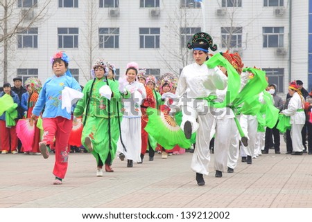 LUANNAN COUNTY - FEBRUARY 21: During the Chinese Lunar New Year, people wear colorful clothes, yangko dance performances in the street, on February 21, 2013, Luannan County, Hebei Province, China.