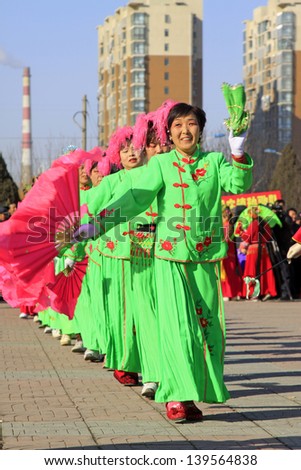 LUANNAN COUNTY - FEBRUARY 22: During the Chinese Lunar New Year, people wear colorful clothes, yangko dance performances in the street, on February 22, 2013, Luannan County, Hebei Province, China.