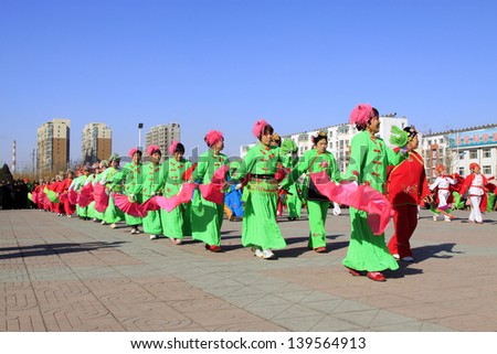 LUANNAN COUNTY - FEBRUARY 22: During the Chinese Lunar New Year, people wear colorful clothes, yangko dance performances in the street, on February 22, 2013, Luannan County, Hebei Province, China.