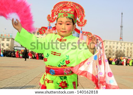 LUANNAN COUNTY - FEBRUARY 23: During the Chinese Lunar New Year, people wear colorful clothes, yangko dance performances in the streets, on February 23, 2013, Luannan County, Hebei Province, China.