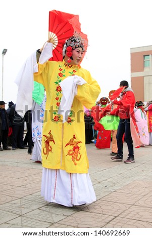 LUANNAN COUNTY - FEBRUARY 24: During the Chinese Lunar New Year, people wear colorful clothes, yangko dance performances in the streets, on February 24, 2013, Luannan County, Hebei Province, China.