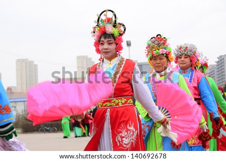 LUANNAN COUNTY - FEBRUARY 25: During the Chinese Lunar New Year, people wear colorful clothes, yangko dance performances in the streets, on February 25, 2013, Luannan County, Hebei Province, China.