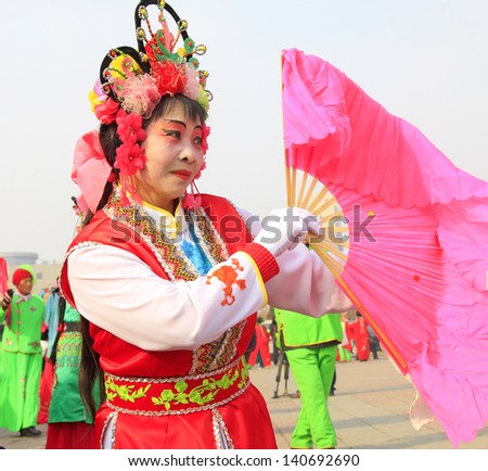 LUANNAN COUNTY - FEBRUARY 26: During the Chinese Lunar New Year, people wear colorful clothes, yangko dance performances in the streets, on February 26, 2013, Luannan County, Hebei Province, China.