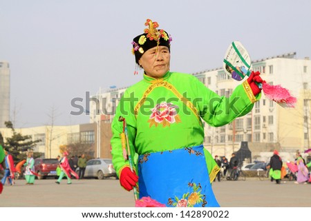 LUANNAN COUNTY - FEBRUARY 26: During the Chinese Lunar New Year, people wear colorful clothes, yangko dance performances in the streets, on February 26, 2013, Luannan County, Hebei Province, China.