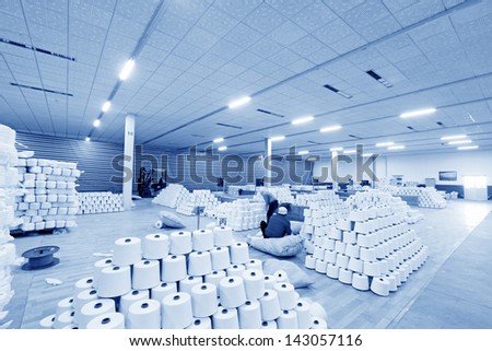 Piles of spindles stacked together in a warehouse