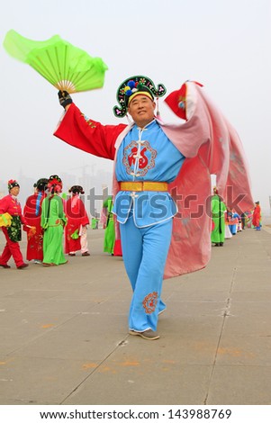 LUANNAN COUNTY - FEBRUARY 27: During the Chinese Lunar New Year, people wear colorful clothes, yangko dance performances in the streets, on February 27, 2013, Luannan County, Hebei Province, China.
