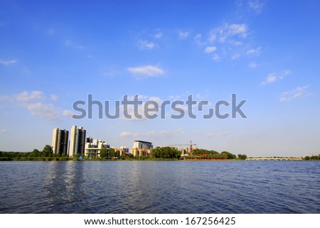 LUANNAN COUNTY, CHINA - AUGUST 30: The High-rise buildings standing at the water\'s edge in the North River Park, on August 30, 2013, LuanNan county, Hebei province, China.