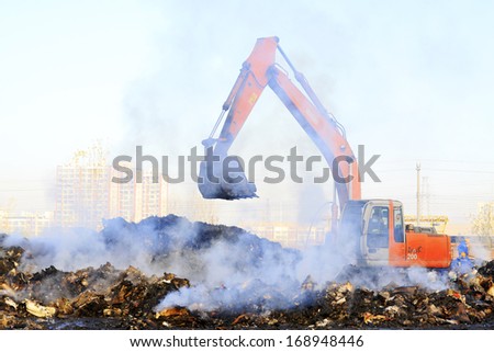 TANGSHAN - NOVEMBER 20: The excavators were clearing up rubbish after fire, November 20, 2013, tangshan city, hebei province, China.