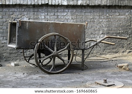old iron strollers in a factory, closeup of photo