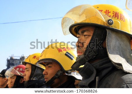 TANGSHAN - NOVEMBER 20: The firemen preparing to leave the fire scene after the fire, November 20, 2013, tangshan city, hebei province, China.