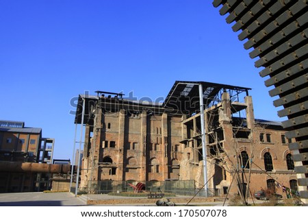 TANGSHAN - NOVEMBER 4: The gears and abandoned factories in the Qixin cement plant on november 4, 2013, tangshan city, hebei province, China.